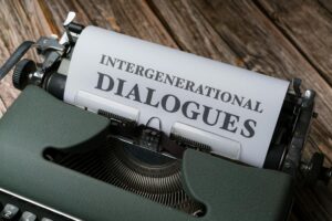 Close-up of a vintage typewriter with paper reading 'Intergenerational Dialogues'.