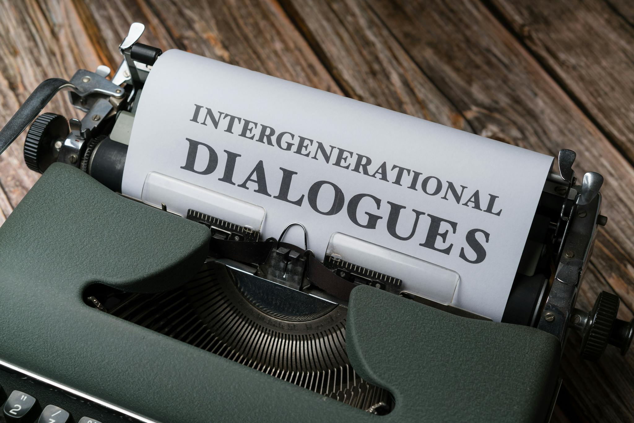 Close-up of a vintage typewriter with paper reading 'Intergenerational Dialogues'.