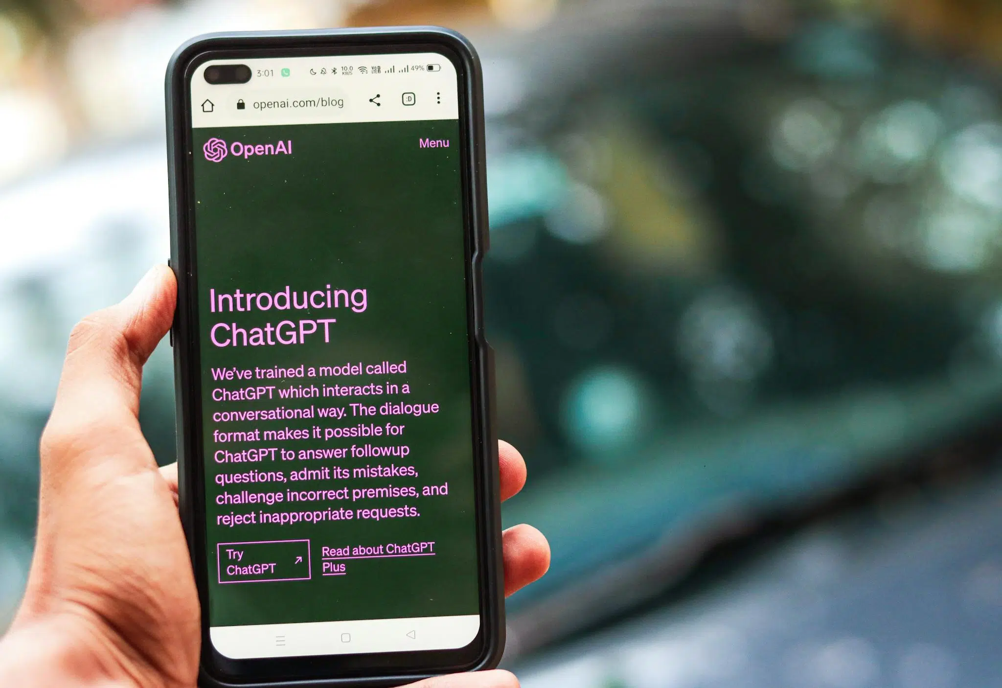 Reviews 1 Close-up of a smartphone showing ChatGPT details on the OpenAI website, held by a person.